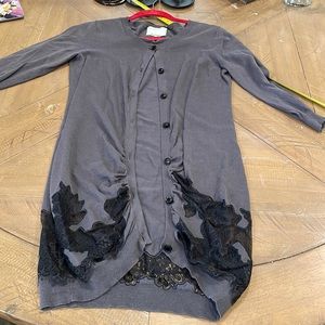 Gray cardigan with black lace detail across bottom.